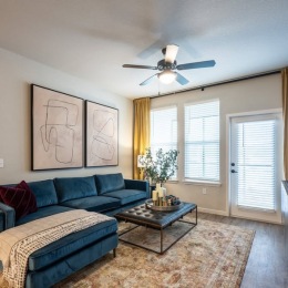 living room with furniture ceiling fan and windows