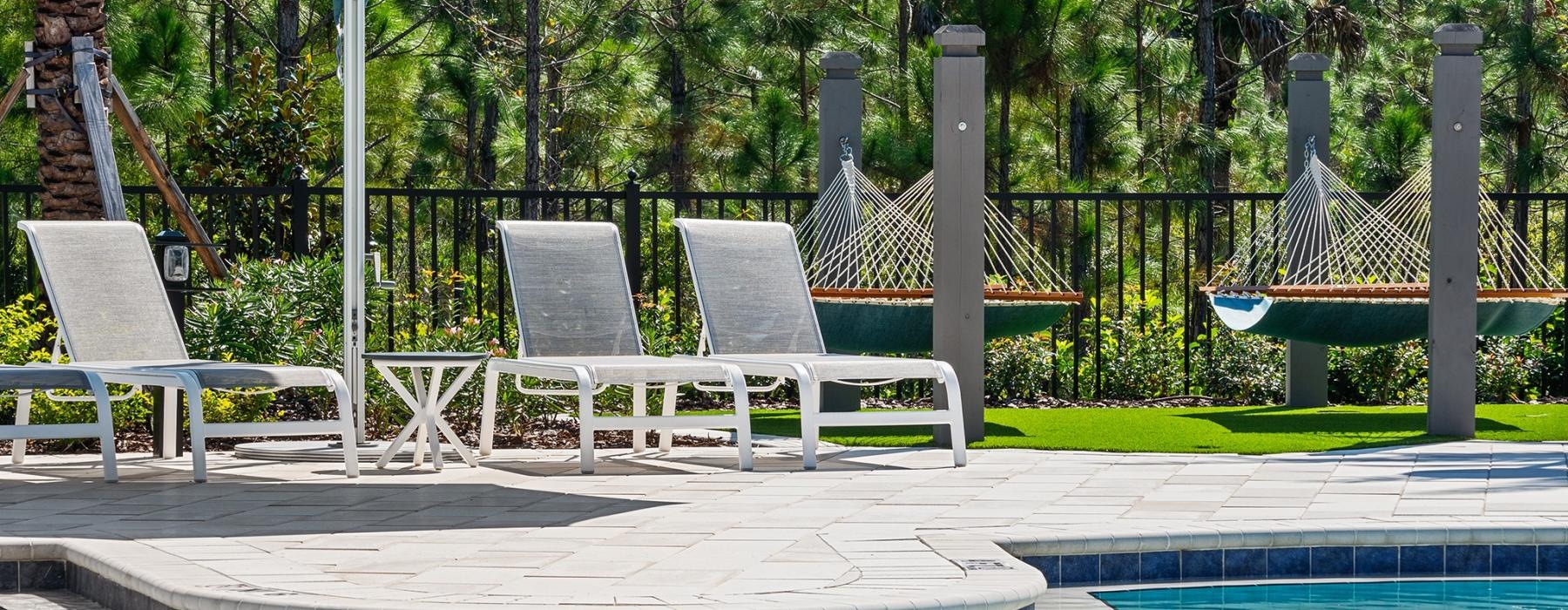 a pool with chairs and umbrella